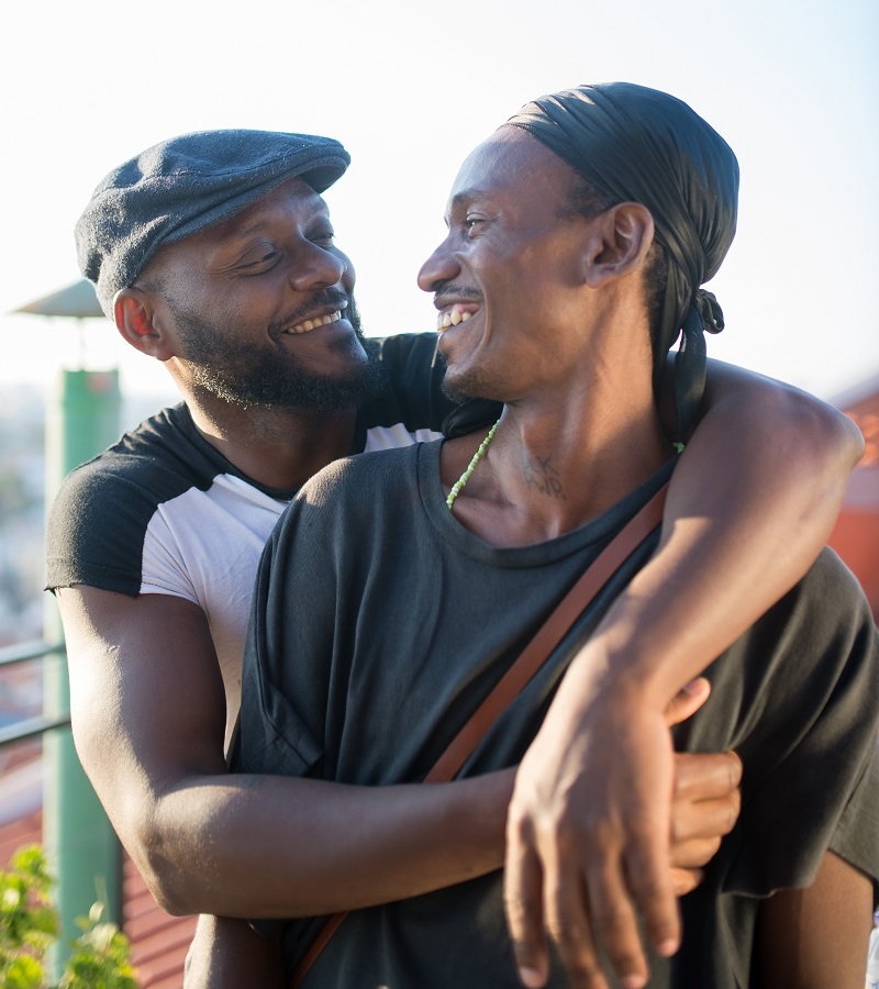 Portrait Of Romantic African Gay Couple Hugging For Photo